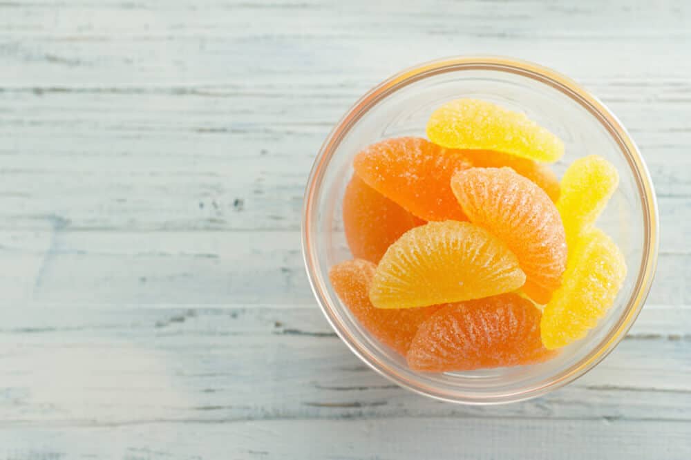 homemade gummy candies in a glass dish on a light blue table
