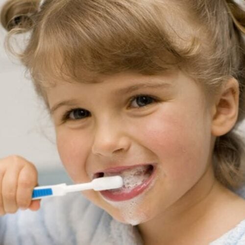 little girl brushing her teeth