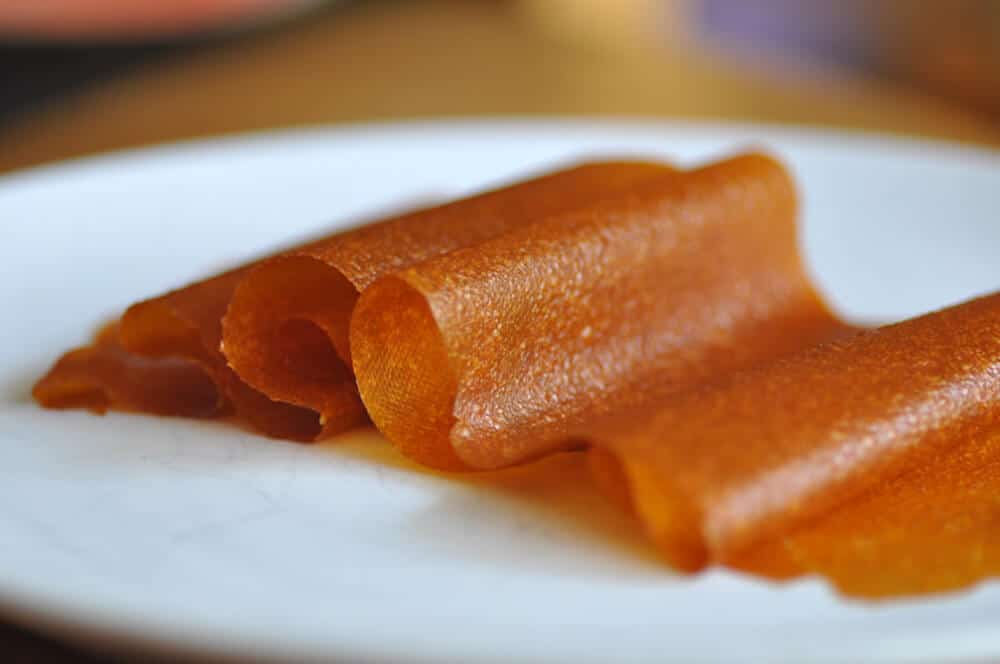 apricot fruit leather on a white plate