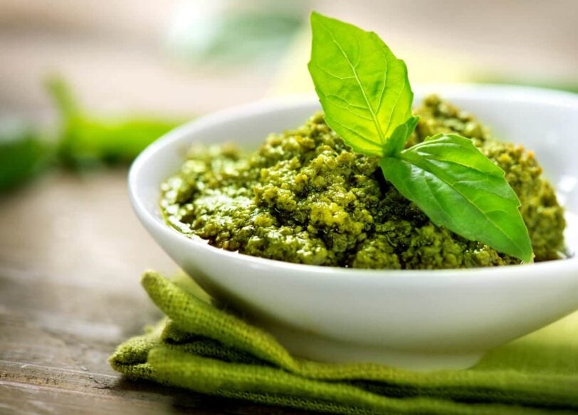basil walnut pesto in a white dish on a table.