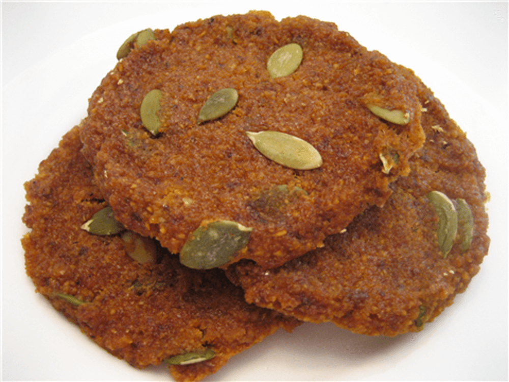 butternut squash cookies on a counter with pepitas on them