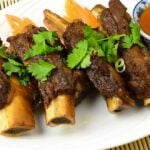pork spare ribs seasoned with Chinese 5-spice on a plate with cilantro garnish