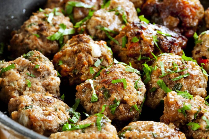 gluten free meatballs on a tray with herbs