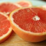 pink grapefruit halves on a countertop