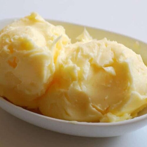 homemade butter in a white dish on a white table